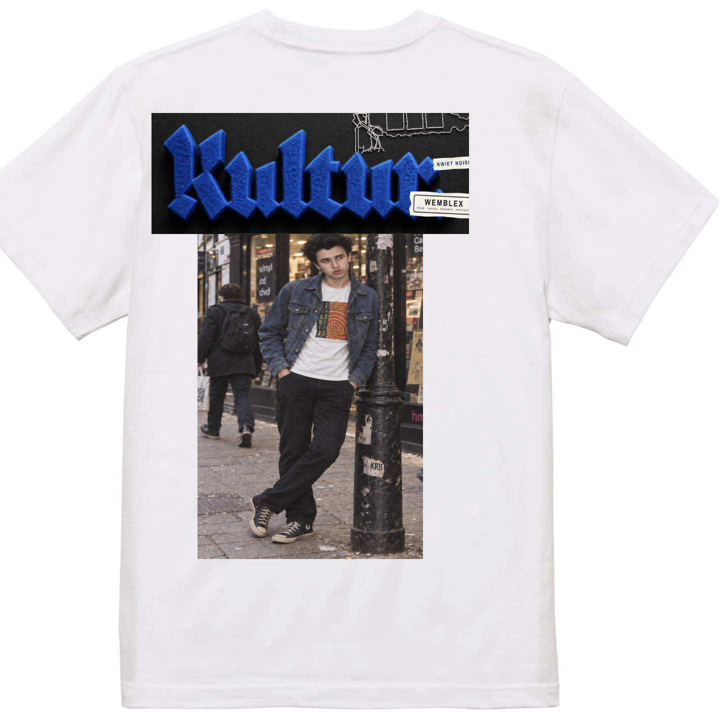White t-shirt with a blue felt Kulture print above a photo of a boy leaning against a lamppost